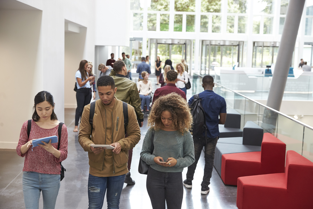 Millennial students using devices to research TaxBandits